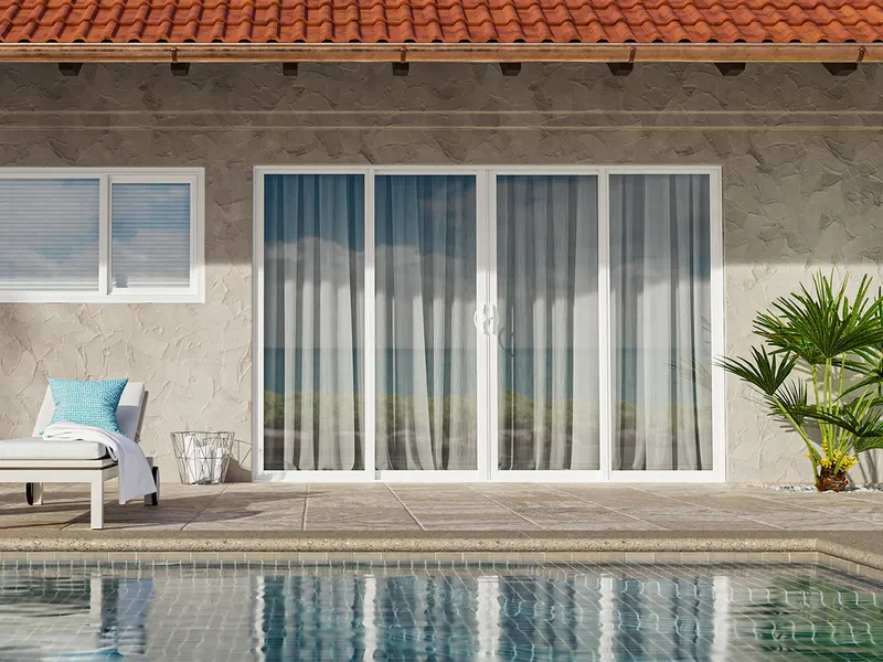 Bi-parting white sliding patio door with sheer curtains opening to a pool deck