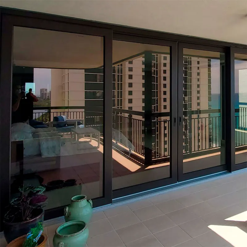 Condo interior with dark-framed sliding glass doors opening to a balcony