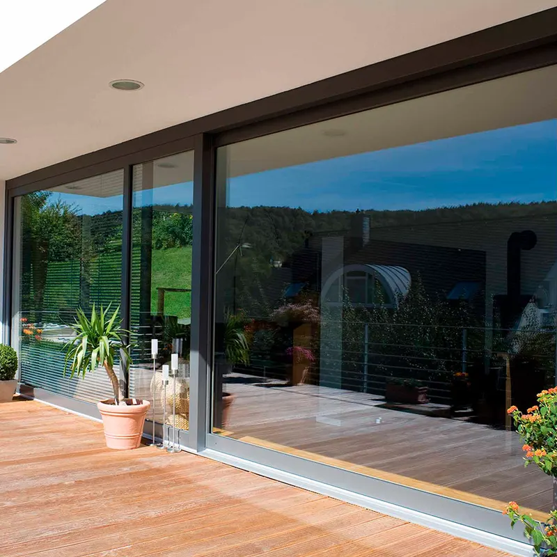 Large dark-framed sliding glass doors opening to a wooden deck