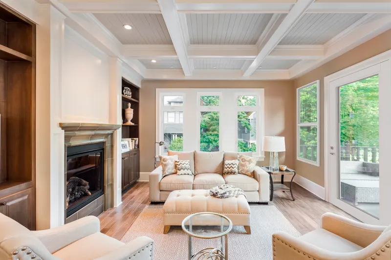 Family room with fireplace and white-framed French doors with grids