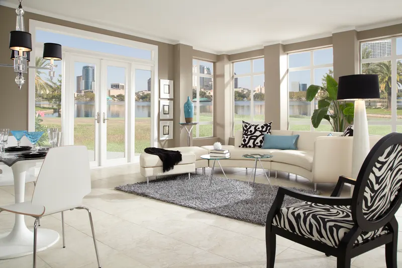 Living room with white French doors flanked by sidelites and transoms