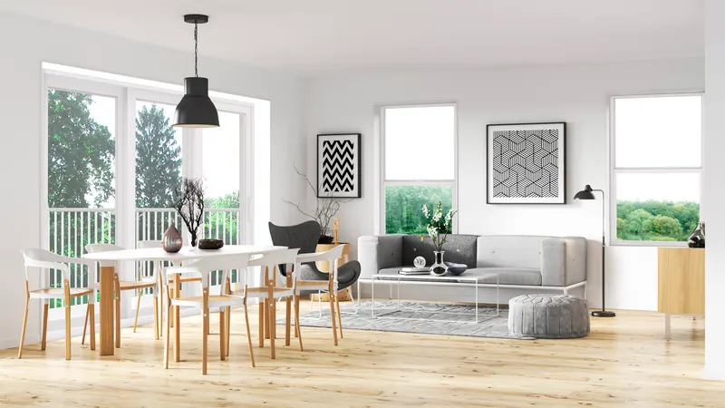 Bright dining and living area with a white sliding glass door and single hung windows